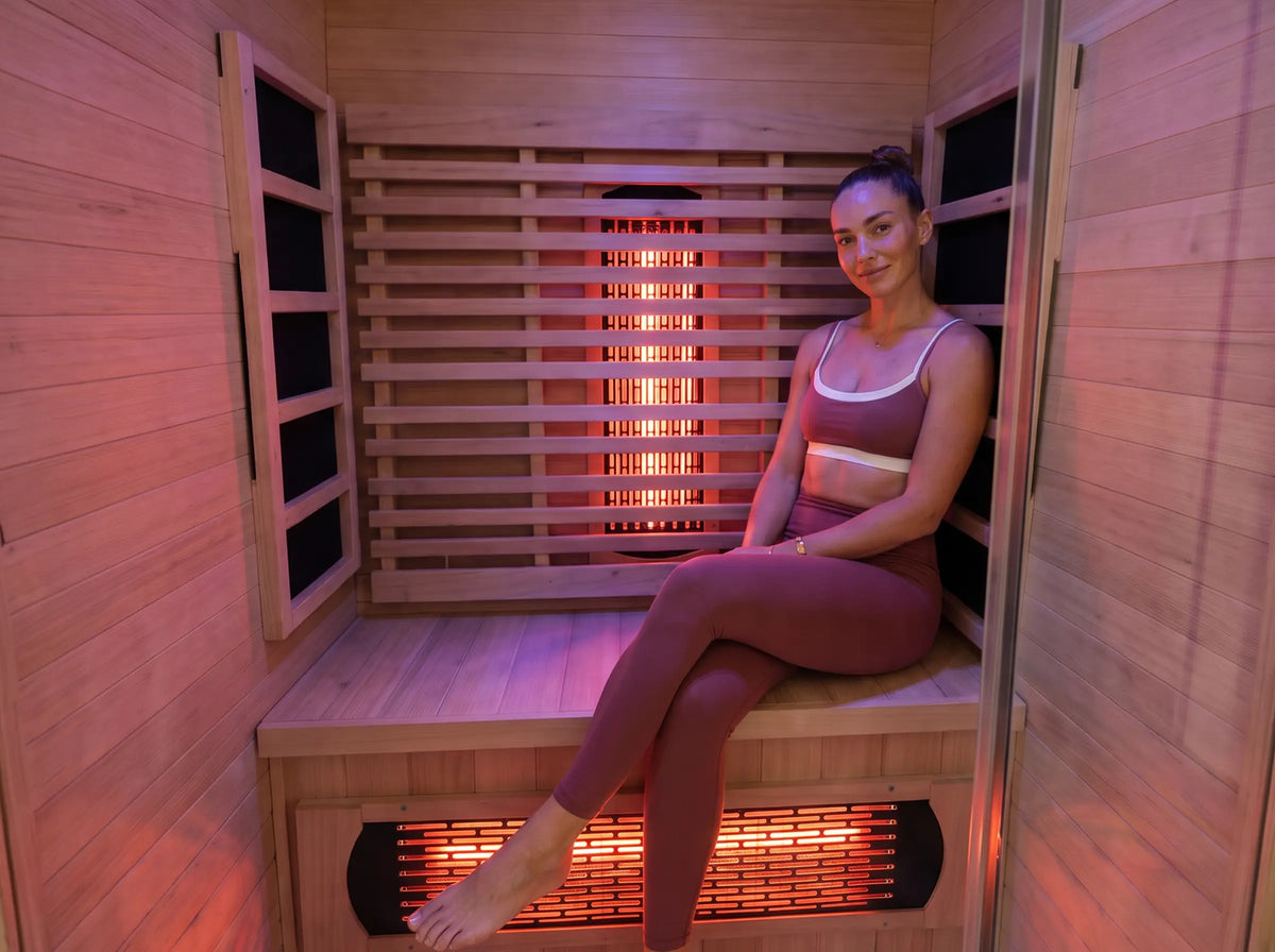 A person sitting inside the infrared sauna cabin