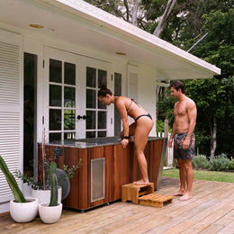 Couple next to the 2-Person Cedar Ice Bath with Chiller on a porch