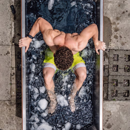 Top view of a man in the 2-Person Cedar Ice Bath with Chiller with ice