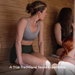 Two women relaxing inside the 4-Person Outdoor Traditional Cedar Sauna