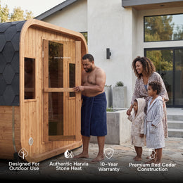 Family walking to the 4-Person Outdoor Traditional Cedar Sauna next to the house