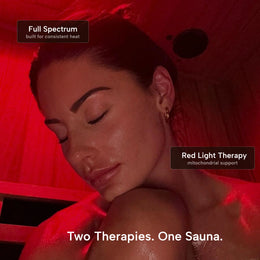 Woman under red light in the 3-Person Red Light + Full Spectrum Hemlock Sauna