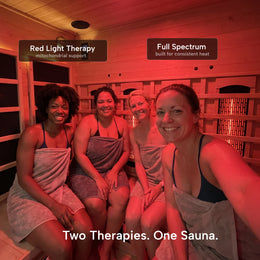 Four women smiling inside the 4-Person Red Light + Full Spectrum Cedar Sauna