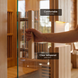 Hand opening the tempered glass door of the 2-Person Infrared Hemlock Sauna