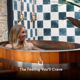 Woman in the 1-Person Cedar Ice Bath in a tiled bathroom