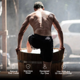 Man stepping into the 1-Person Cedar Ice Bath outdoors, feature icons