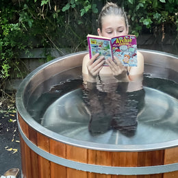 Woman reading a magazine in the 1-Person Cedar Ice Bath