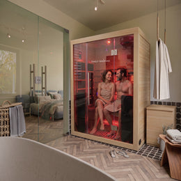 Two women inside the 3-Person Red Light + Full Spectrum Hemlock Sauna