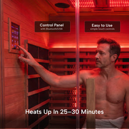 Man using the control panel inside the 2-Person Red Light + Full Spectrum Hemlock Sauna